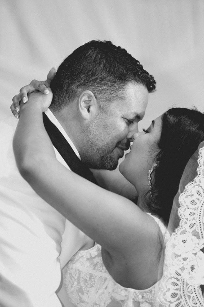 A couple shares a tender moment during their wedding in New Orleans, capturing love and joy on their.