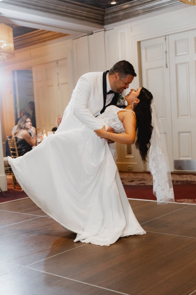Bride and groom sharing a romantic dance during their wedding celebration in a beautifully decorated.