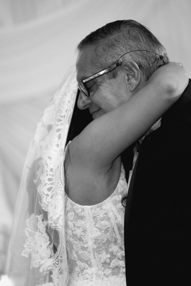 Wedding embrace of bride and her father in New Orleans, captured by Matthew Foster.