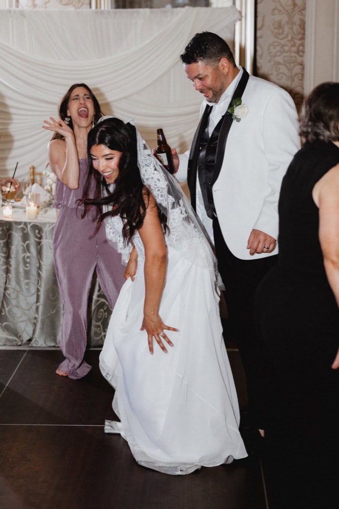 Wedding celebration in New Orleans with joyful bride and groom dancing.