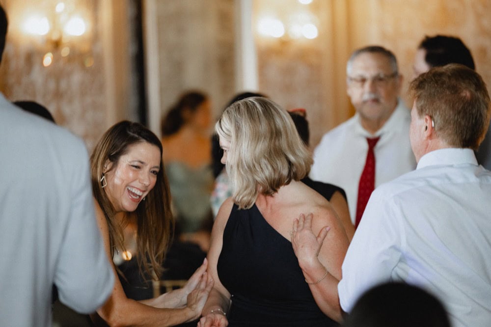 Celebrating love and happiness at a wedding reception in New Orleans with lively guests.