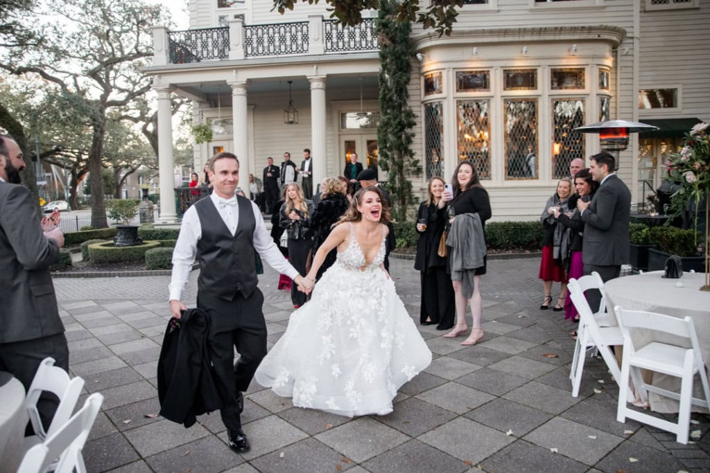 Wedding couple celebrating outdoors in New Orleans with friends and family.