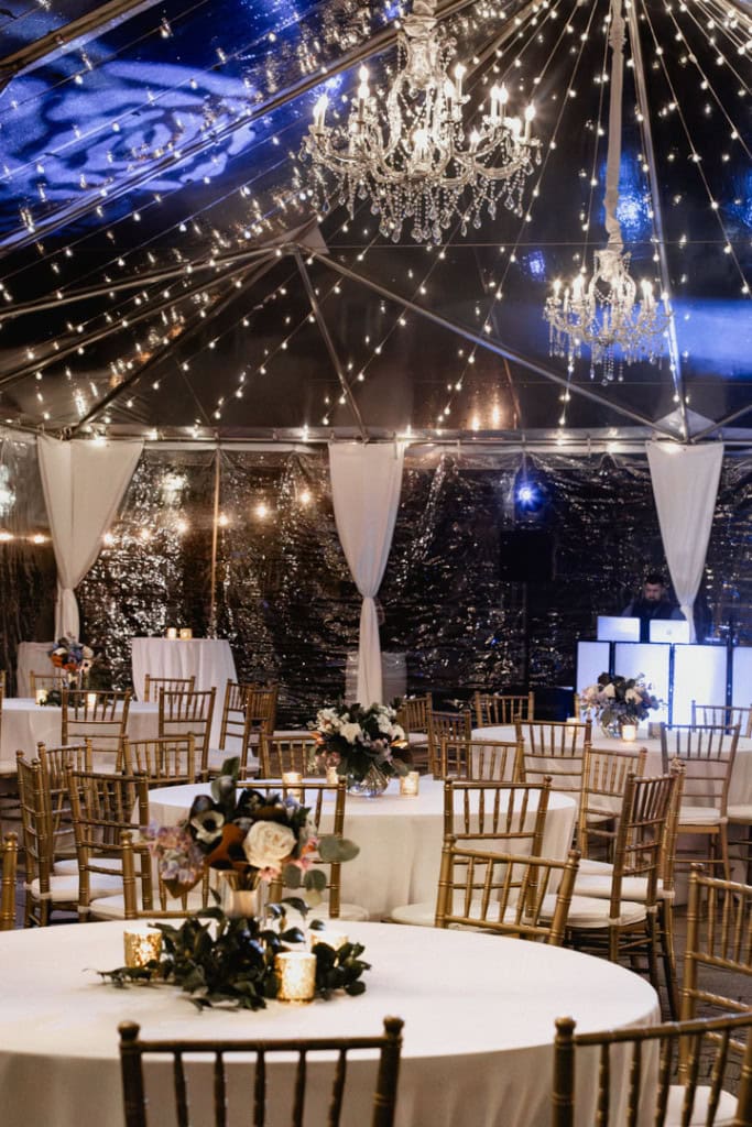 Beautiful wedding reception with chandeliers, fairy lights, and floral centerpieces in New Orleans.