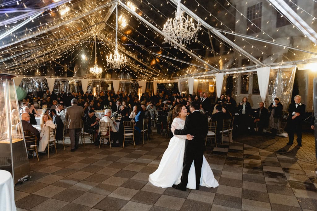 Bride and groom dancing at a wedding reception in New Orleans with elegant decor.