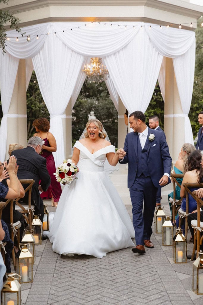Bride and groom celebrating at outdoor wedding ceremony in New Orleans.