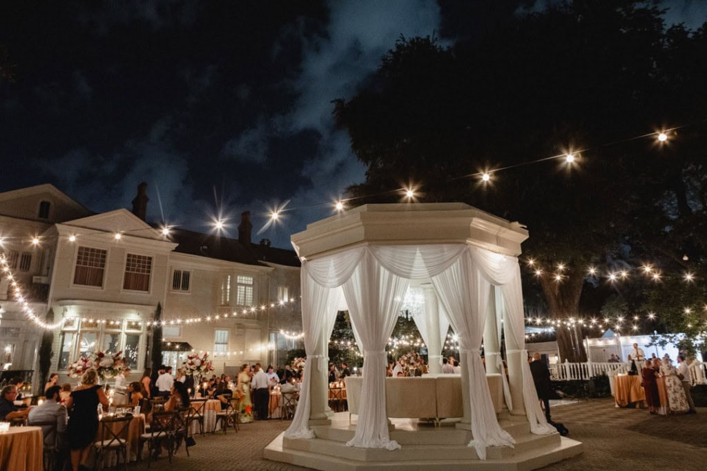 Nighttime wedding reception in New Orleans with string lights and elegant decor.