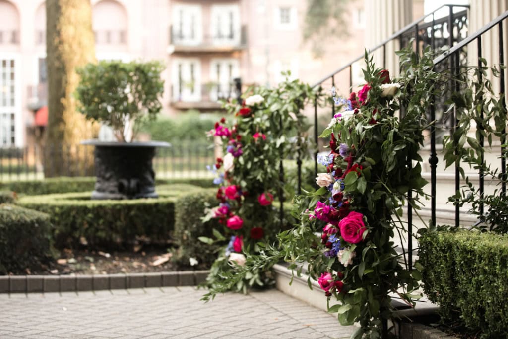 Elegant wedding floral arrangements on staircase in New Orleans.