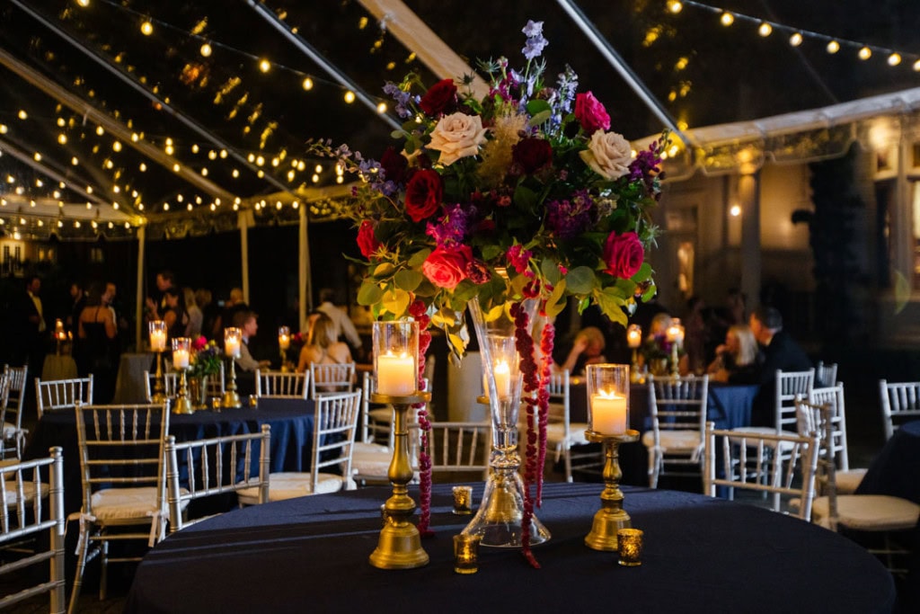 Beautiful floral centerpiece with candles at New Orleans wedding reception.