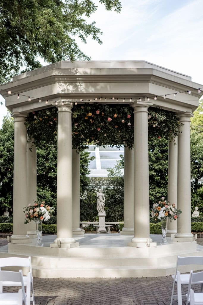 Elegant wedding pavilion with columns and floral arrangements in New Orleans.