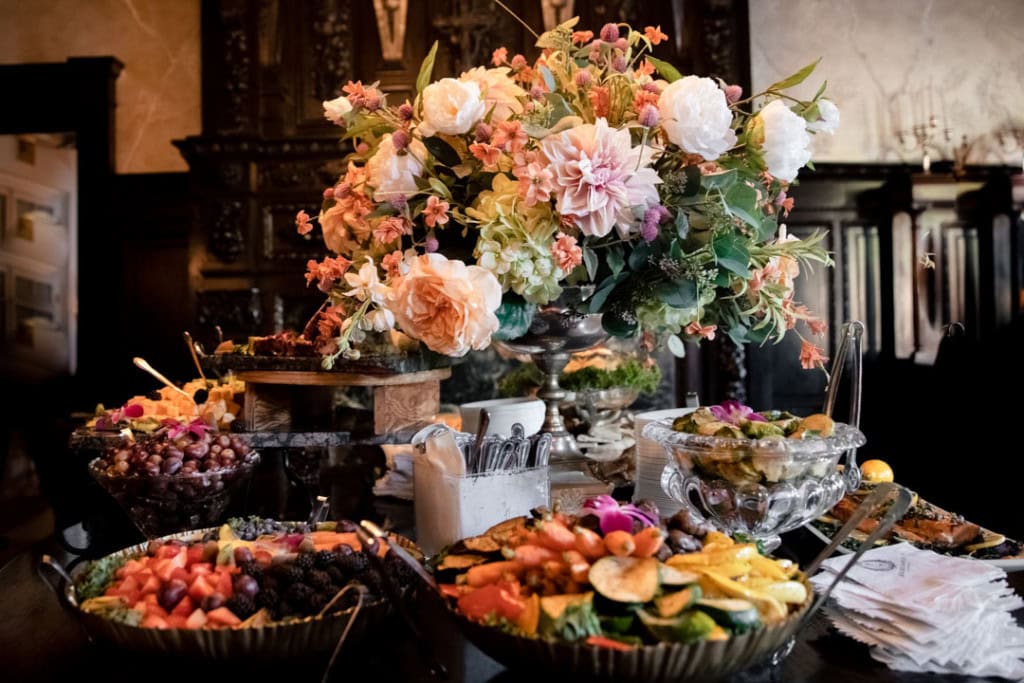 Beautiful wedding dessert table with flowers and assorted treats in New Orleans.