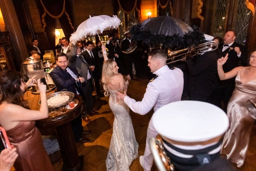 Couple dancing at wedding reception with live band and guests.