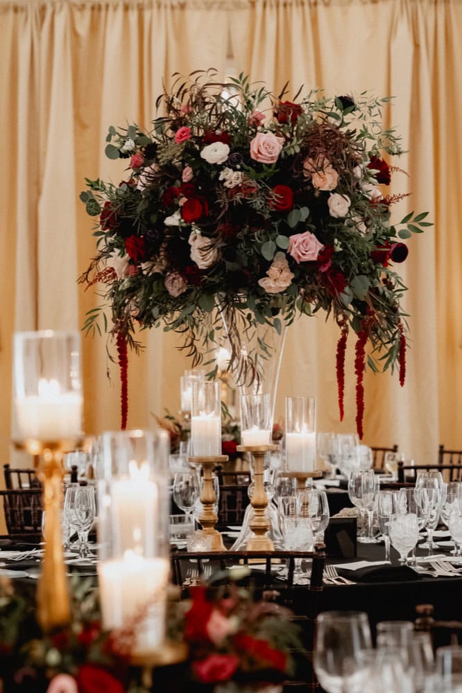 Beautiful floral wedding centerpiece with candles and greenery in New Orleans.