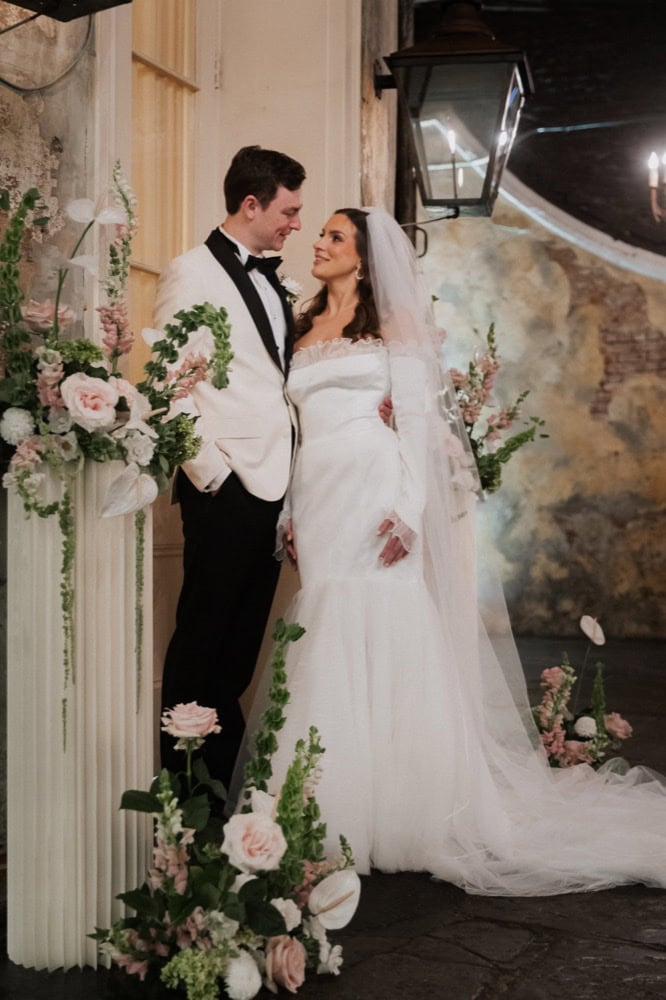 New Orleans wedding photo of bride and groom with floral decor.