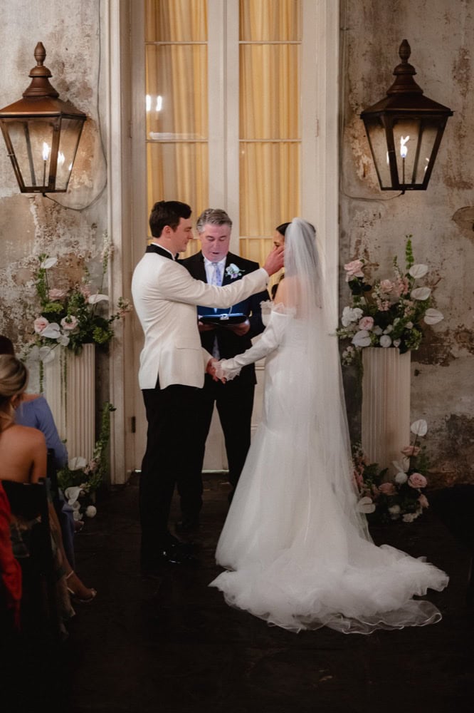 New Orleans wedding ceremony with bride and groom exchanging vows.