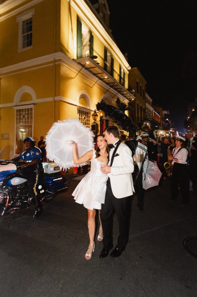 Bride and groom dancing on the street at night in New Orleans.