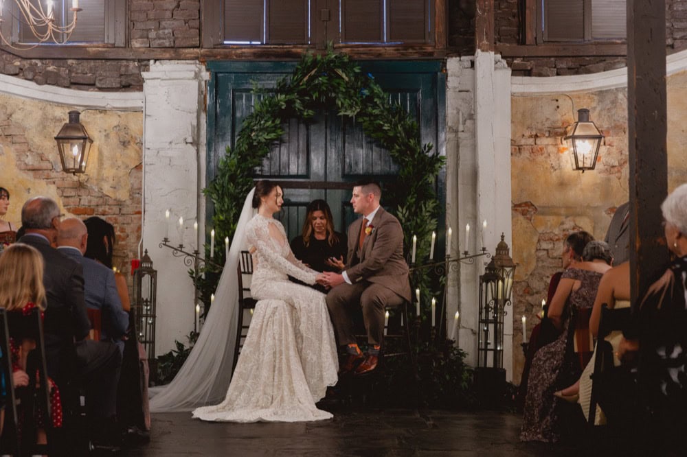Bride and groom exchanging vows at New Orleans wedding venue.