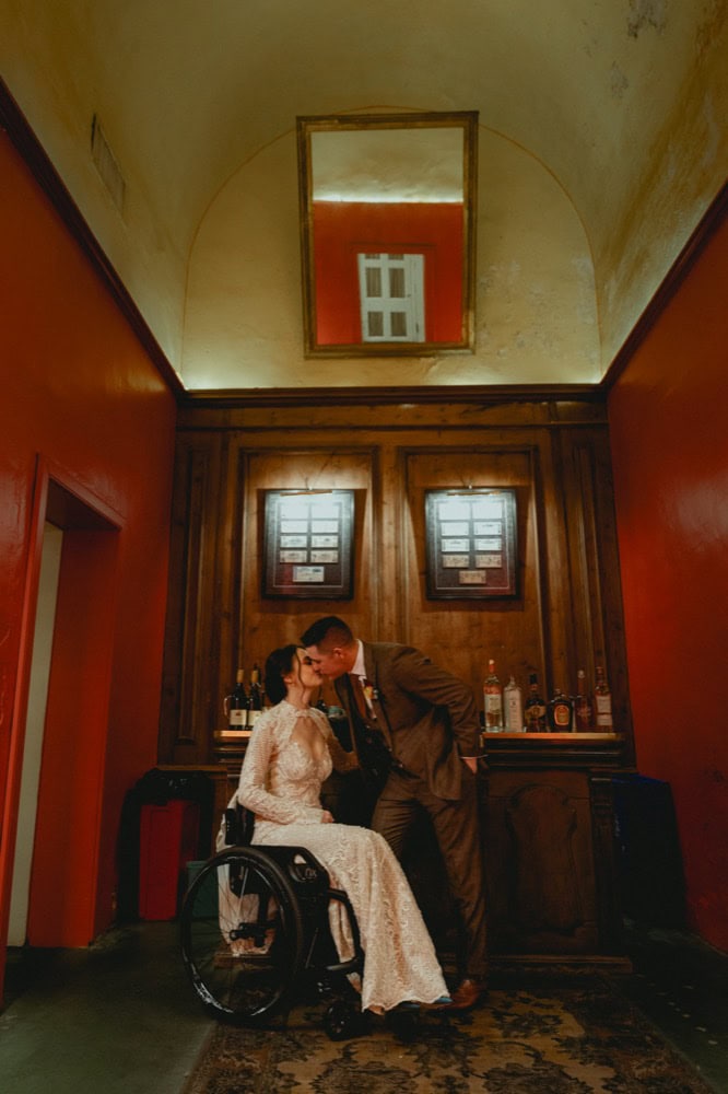 Bride and groom share a kiss in a historic New Orleans venue.