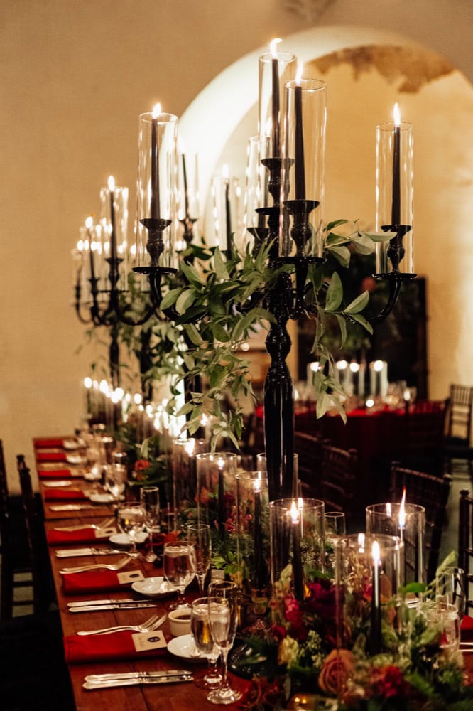 Luxurious wedding reception table with candles and floral arrangements in New Orleans.