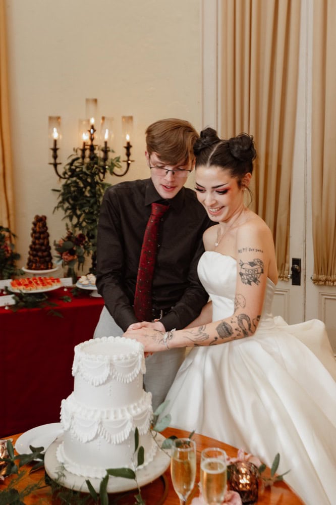 Wedding couple cutting cake at reception, New Orleans style.