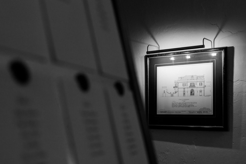 Black and white line sketch artwork of Latrobe's on Royal on the wall and light by an overhead light.