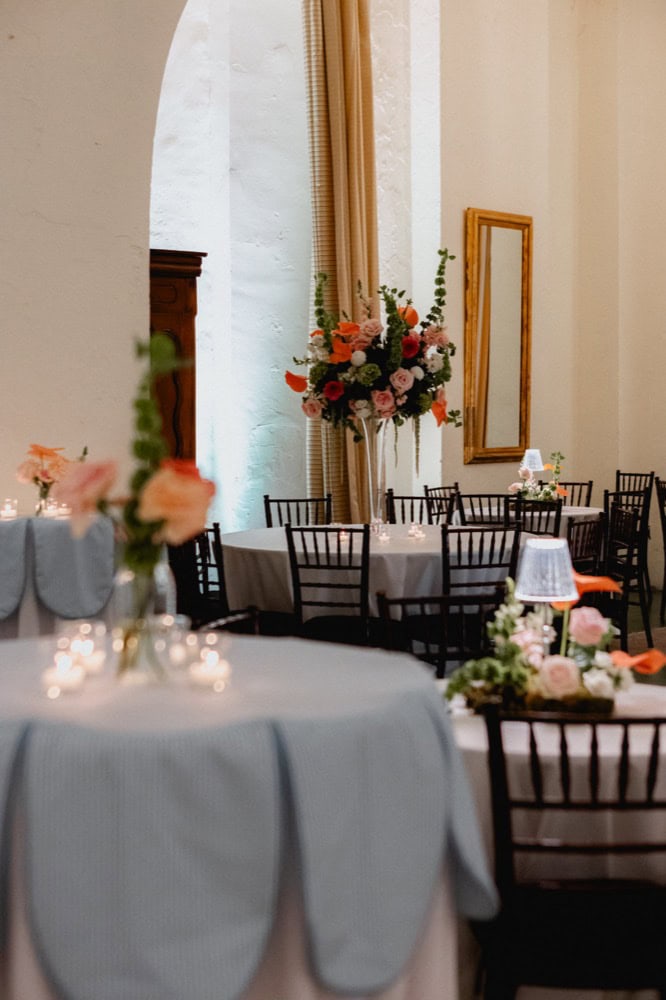 Pastel flowers sit in the center of a table in the wedding reception room of Latrobe's on Royal.