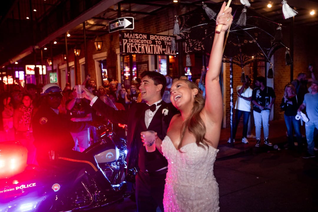 Bride and groom celebrating at a New Orleans wedding in front of Preservation Hall.