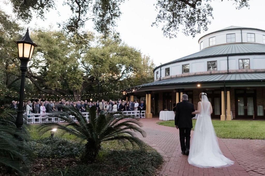 Bride and her father walking towards ceremony at the Audubon Tea Room, outdoor wedding venue in New Orleans.