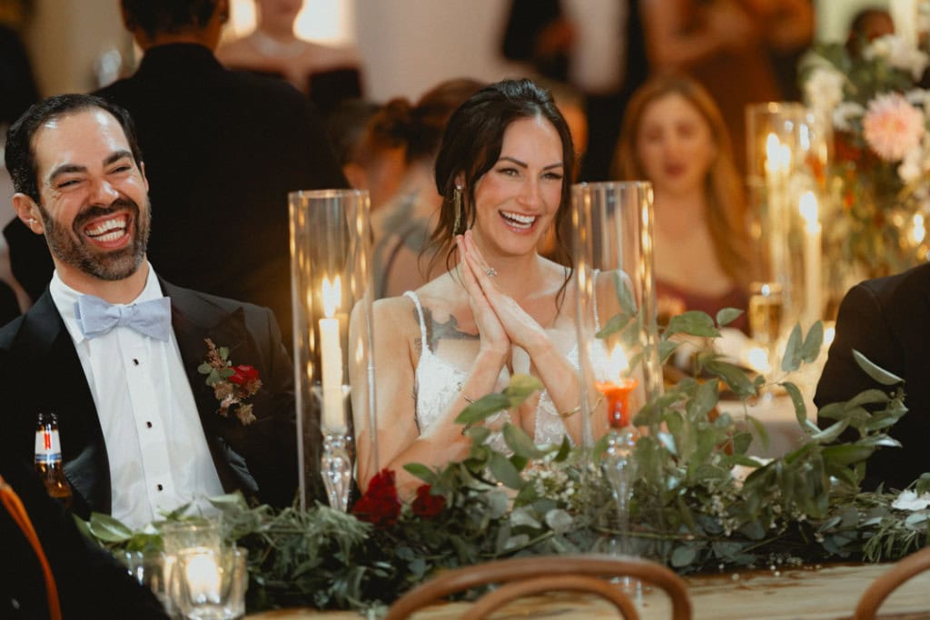 Happy bride and groom at wedding reception in New Orleans with floral decor.