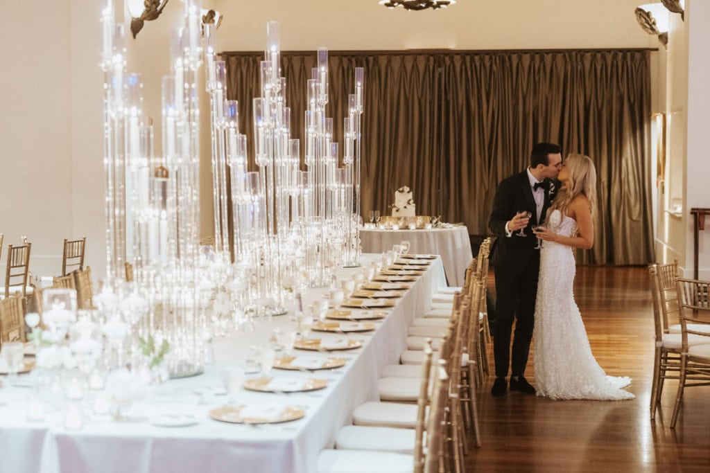 Elegant wedding reception with a long table and chandelier lighting in New Orleans.