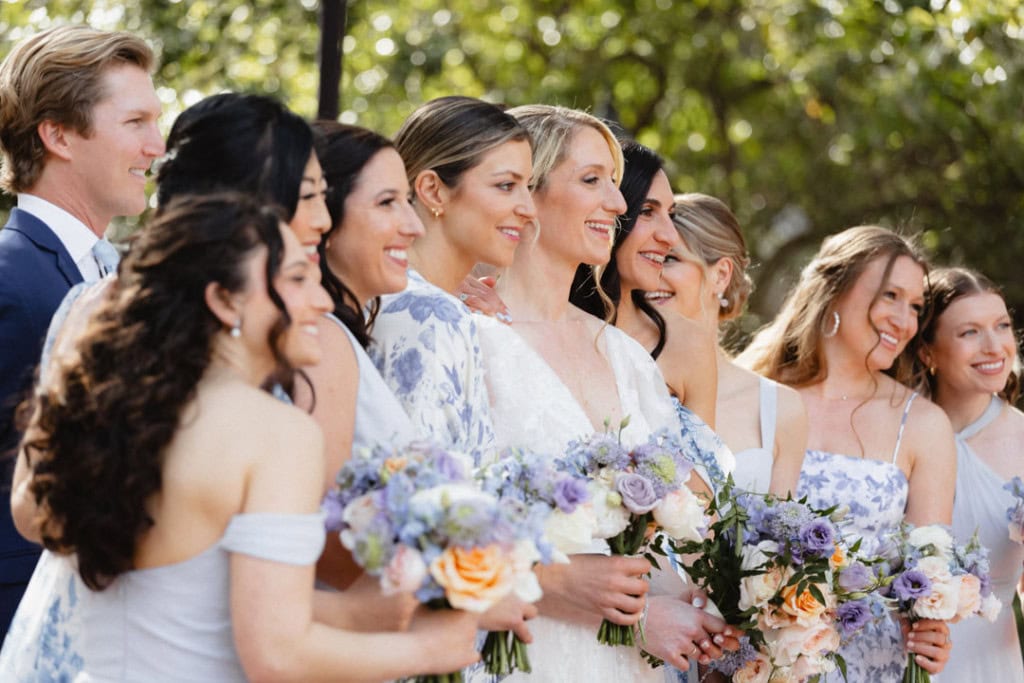 Wedding party in New Orleans with bride and bridesmaids holding bouquets.