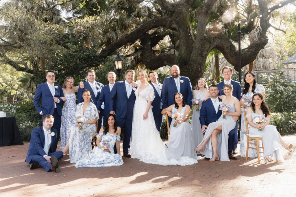 Wedding party photo outdoors with bride, groom, and guests in formal attire at Audubon Tea Room.