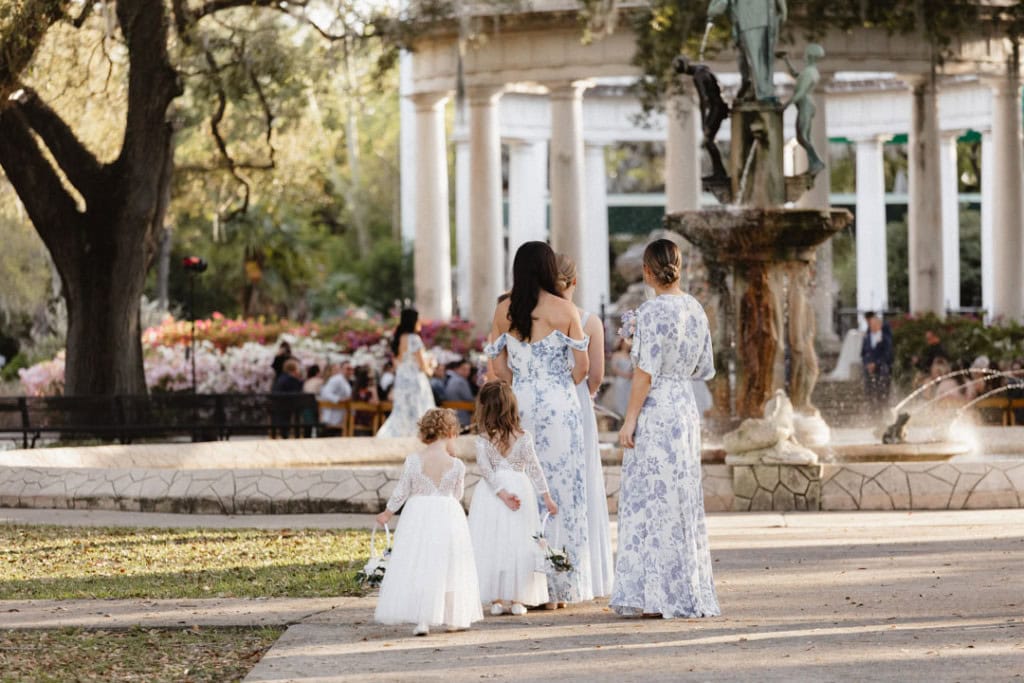 Wedding scene in New Orleans with family and fountain in background.