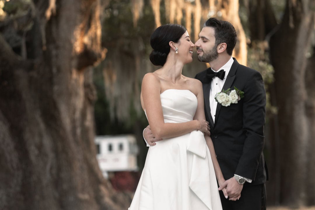 Bride and groom sharing a romantic moment outdoors in New Orleans.