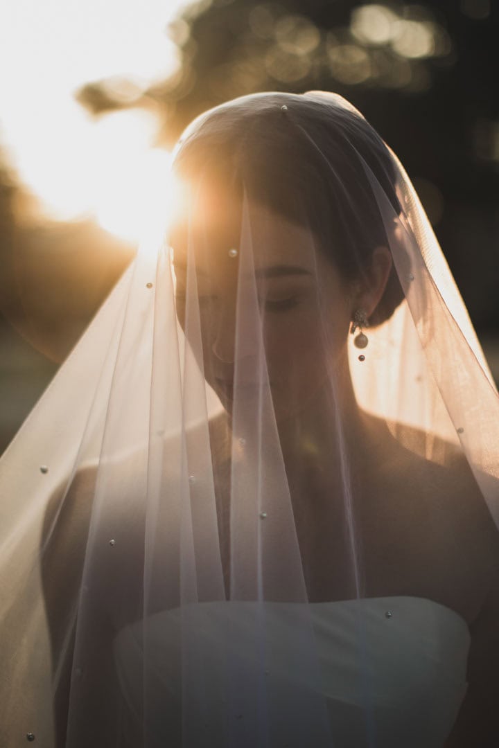 Bride with veil at sunset, New Orleans wedding photography by Matthew Foster.
