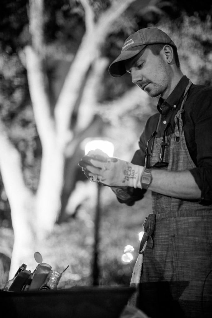 An oyster shucker shucks oysters at a wedding reception in New Orleans.