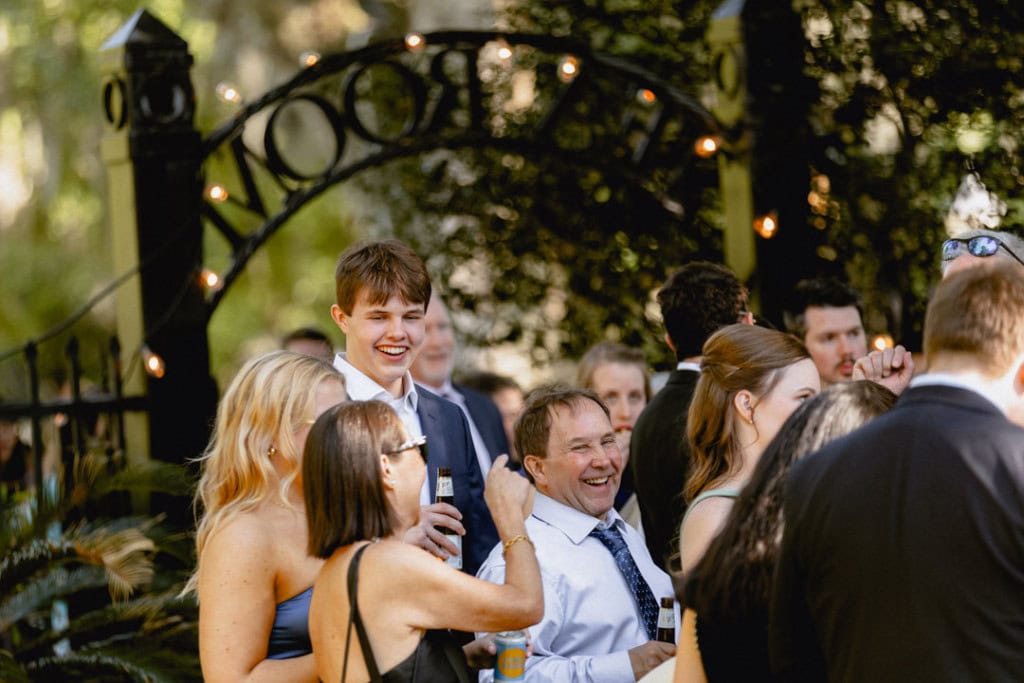 Group of people enjoying a wedding reception outdoors in New Orleans.