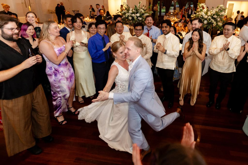 A couple dances while a crowd cheers them on.